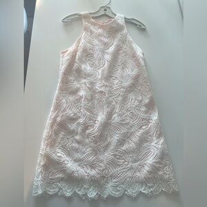Off-white lace dress with pink lining.
